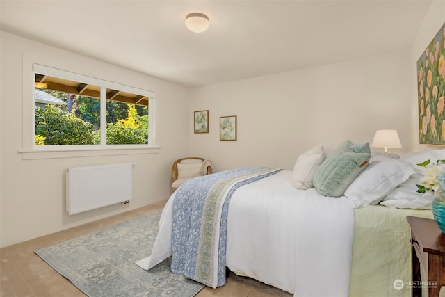 carpeted bedroom with radiator heating unit