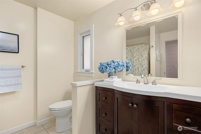 bathroom with tile patterned flooring, vanity, and toilet