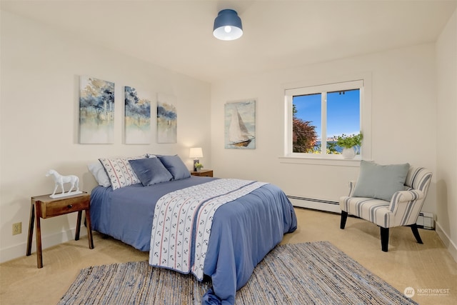 bedroom with baseboard heating and light carpet