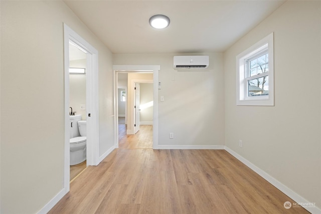 603 Military St, Walla Walla, WA 99362 - hallway featuring a wall mounted AC and light hardwood / wood-style flooring