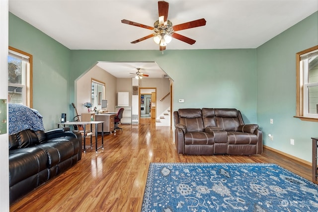 living room featuring hardwood / wood-style flooring and ceiling fan