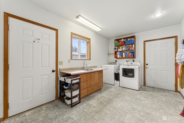 washroom with washing machine and dryer and sink