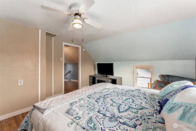 bedroom with hardwood / wood-style floors, ceiling fan, and vaulted ceiling