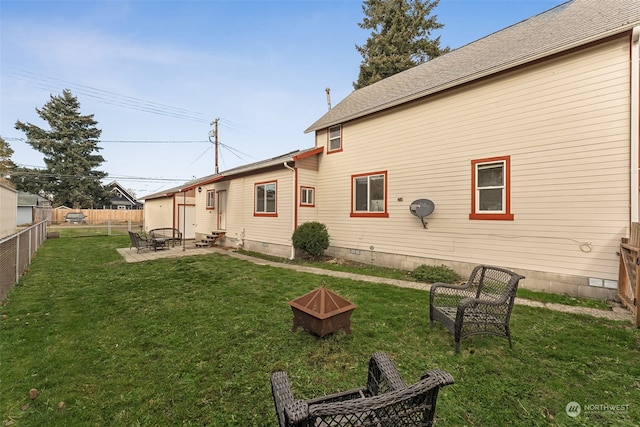 back of property featuring a patio area and a yard