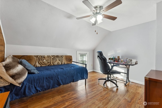 bedroom with ceiling fan, lofted ceiling, and light wood-type flooring