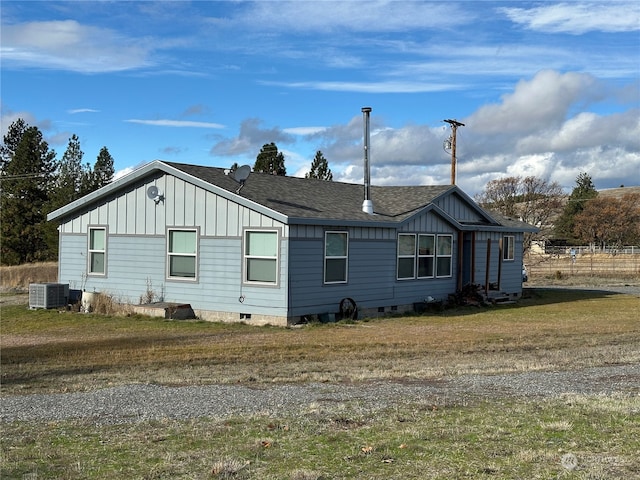 view of side of home with central AC