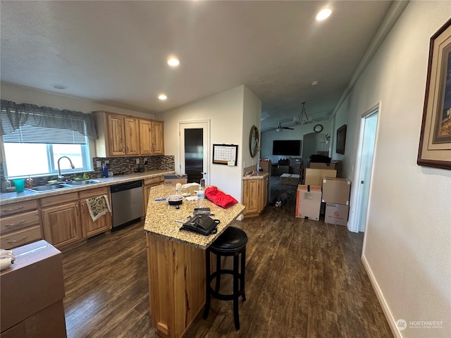 kitchen featuring crown molding, sink, dishwasher, dark hardwood / wood-style floors, and a kitchen island