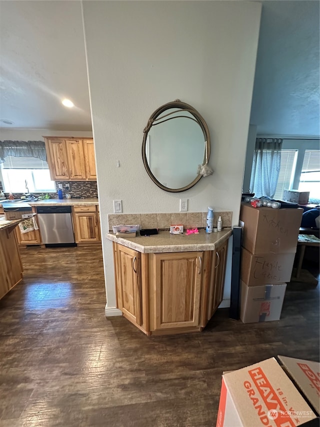 bathroom with decorative backsplash, a wealth of natural light, and hardwood / wood-style flooring