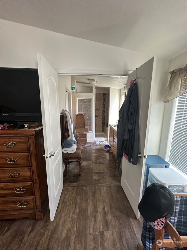 interior space with dark hardwood / wood-style floors and vaulted ceiling