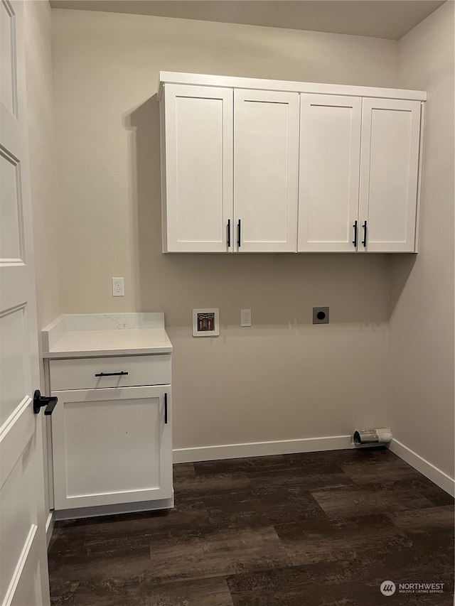 clothes washing area with hookup for an electric dryer, hookup for a washing machine, cabinets, and dark wood-type flooring