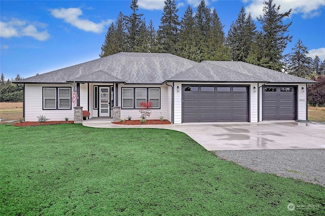 view of front of home featuring a garage and a front lawn