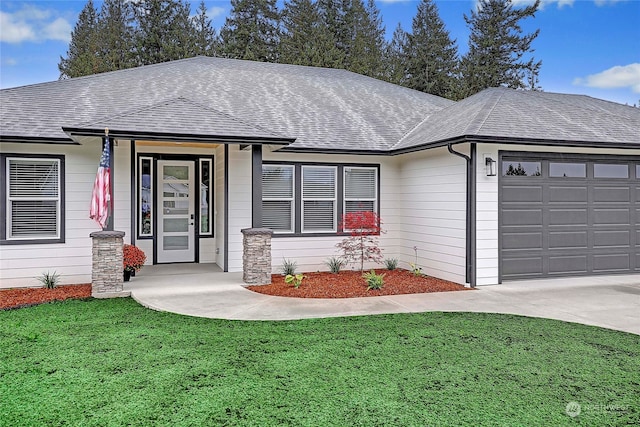 ranch-style home with a front yard and a garage