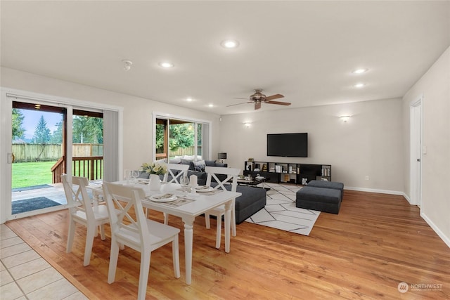 dining area with ceiling fan and light hardwood / wood-style flooring