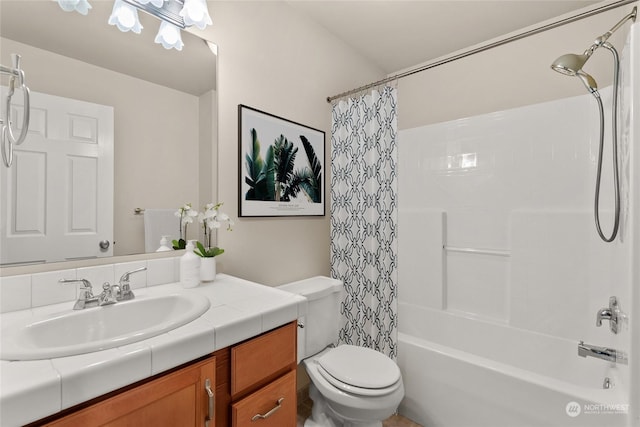 full bathroom with vanity, shower / tub combo, and toilet