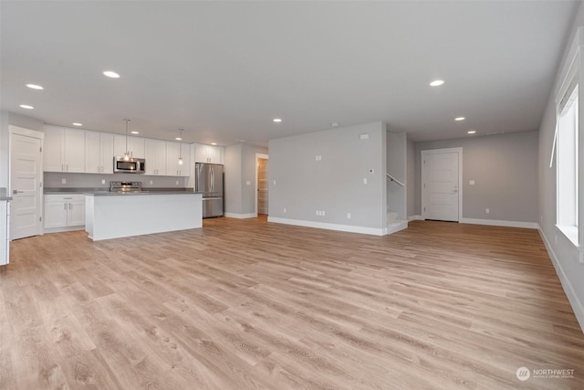 unfurnished living room with light hardwood / wood-style flooring