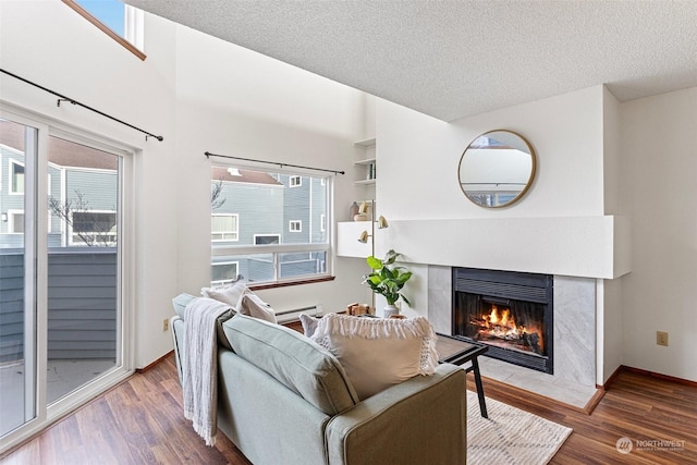 living room with wood-type flooring and a textured ceiling