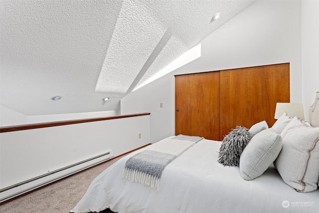 bedroom featuring a textured ceiling, lofted ceiling, baseboard heating, and a closet