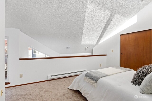 carpeted bedroom with a textured ceiling, lofted ceiling, and a baseboard heating unit