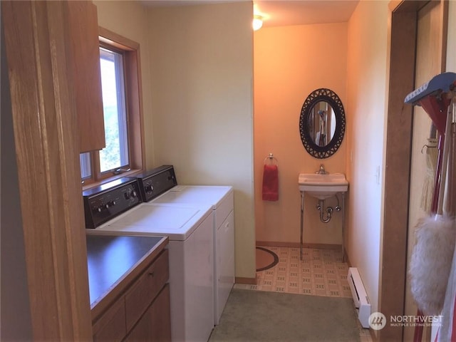 laundry area with washer and clothes dryer and baseboard heating