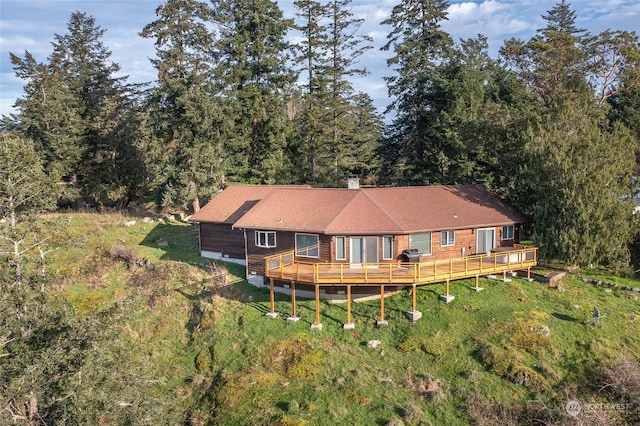 rear view of house with a wooden deck