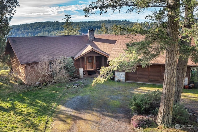 view of front of property featuring a garage and a front lawn