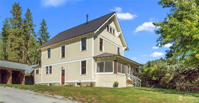 exterior space featuring a sunroom and a front yard