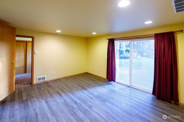 unfurnished room with dark hardwood / wood-style flooring