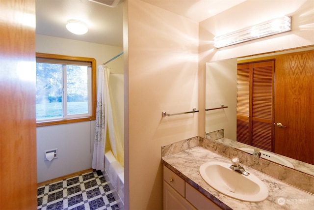 bathroom with vanity and shower / bath combo with shower curtain