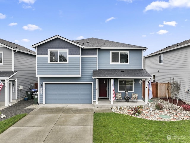 front facade featuring a porch, a garage, and a front lawn