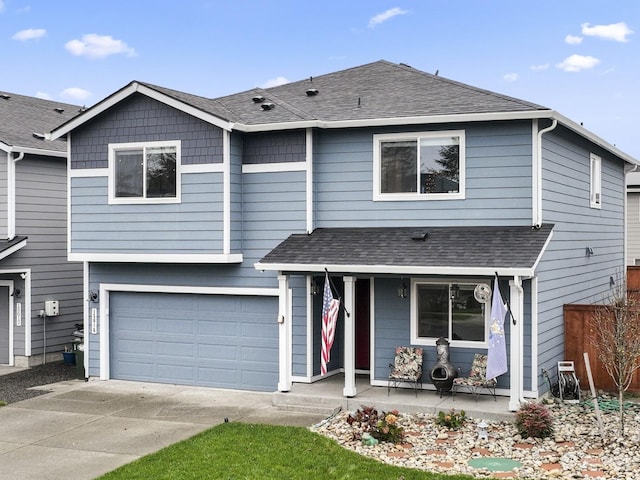 front of property featuring covered porch and a garage