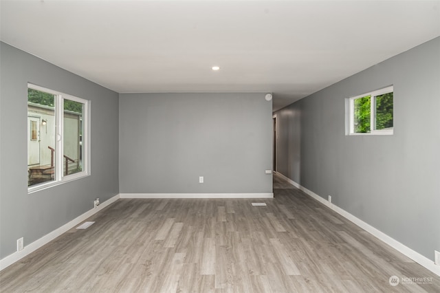 unfurnished room with light wood-type flooring