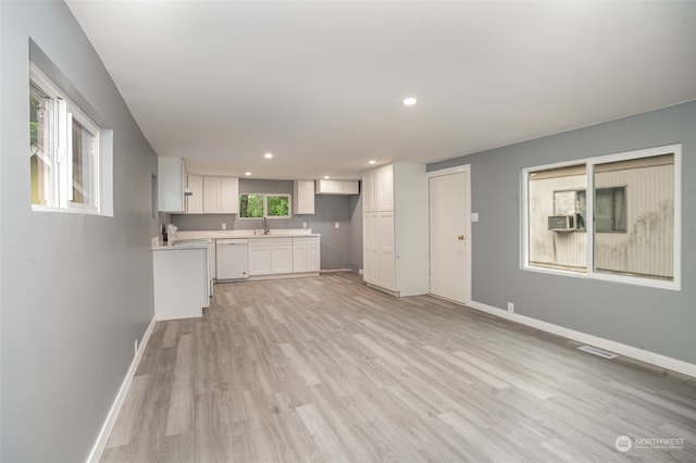 unfurnished living room featuring light wood-type flooring and sink