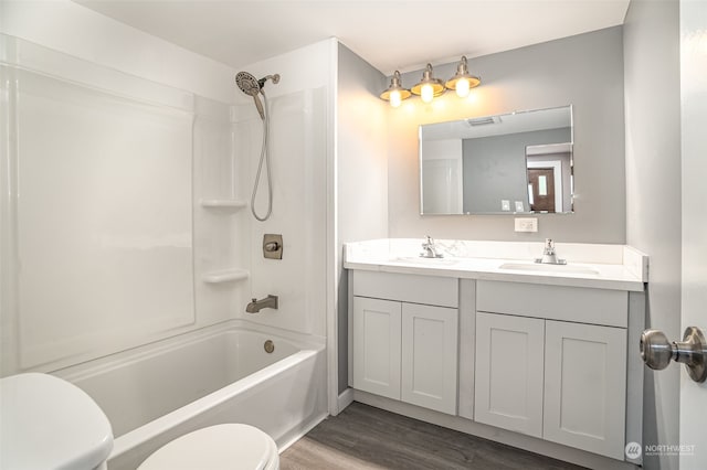 full bathroom featuring vanity, shower / bath combination, hardwood / wood-style flooring, and toilet