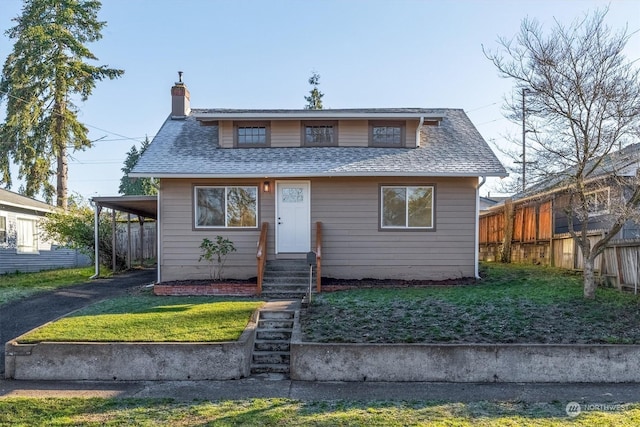 bungalow-style home with a front yard and a carport