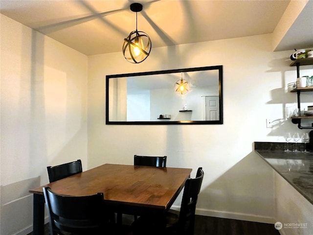 dining space with dark hardwood / wood-style flooring