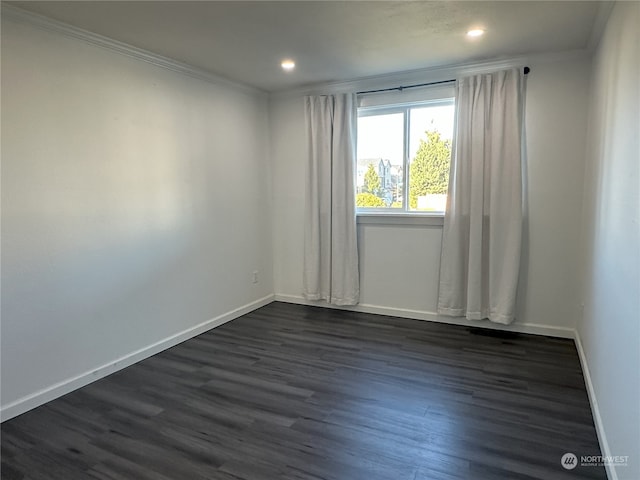 spare room featuring dark hardwood / wood-style flooring and ornamental molding