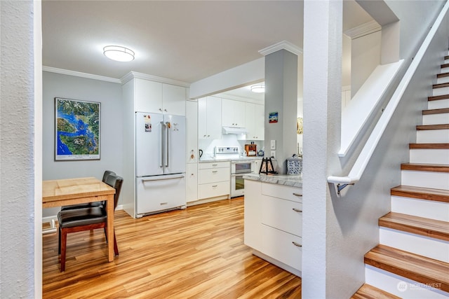 kitchen featuring white cabinetry, white appliances, ornamental molding, and light hardwood / wood-style flooring