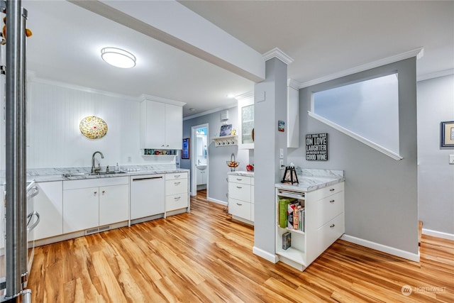 kitchen with light wood-type flooring, white cabinets, crown molding, sink, and dishwasher