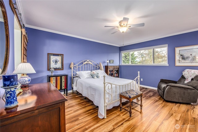 bedroom featuring ceiling fan, light wood-type flooring, and ornamental molding