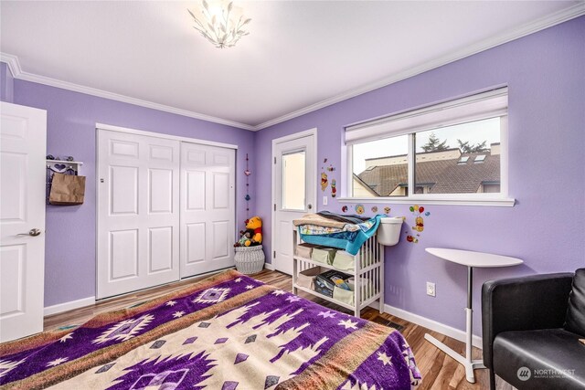 bedroom featuring a closet, ornamental molding, and hardwood / wood-style flooring