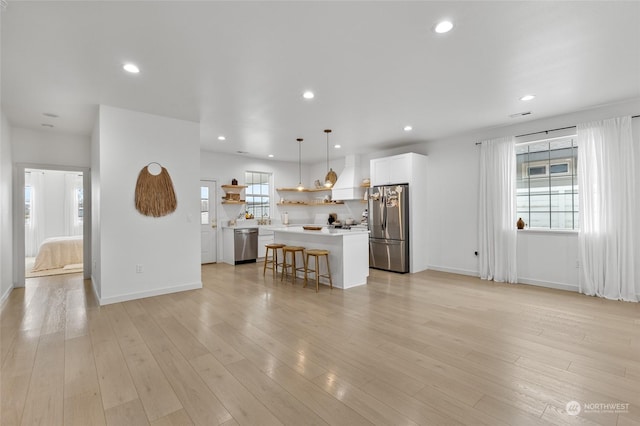 unfurnished living room with light hardwood / wood-style flooring