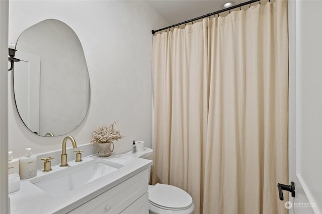 bathroom featuring vanity and toilet