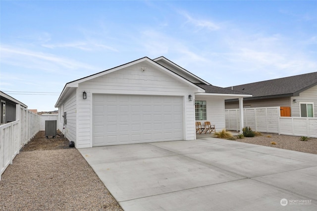 single story home with central AC and a garage