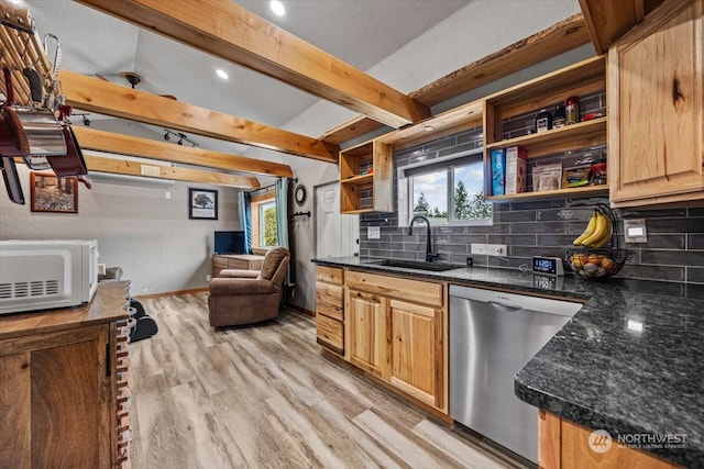 kitchen featuring dishwasher, sink, tasteful backsplash, dark stone countertops, and light hardwood / wood-style floors