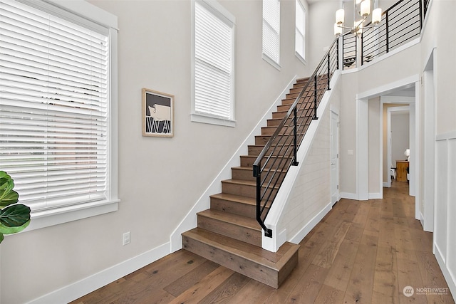 stairway with a healthy amount of sunlight and wood-type flooring