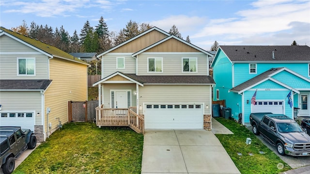 craftsman house with a front lawn and a garage