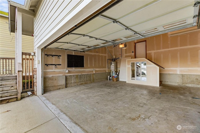 garage featuring a garage door opener and secured water heater