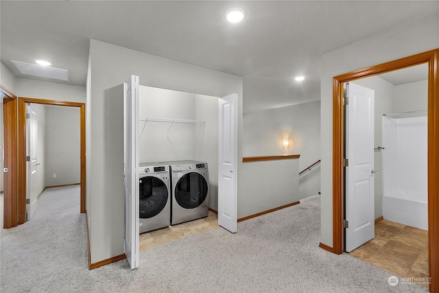 clothes washing area featuring washer and dryer and light colored carpet