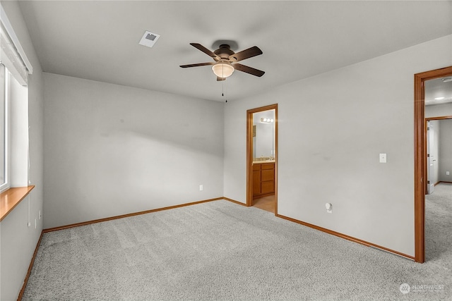 spare room featuring light carpet and ceiling fan