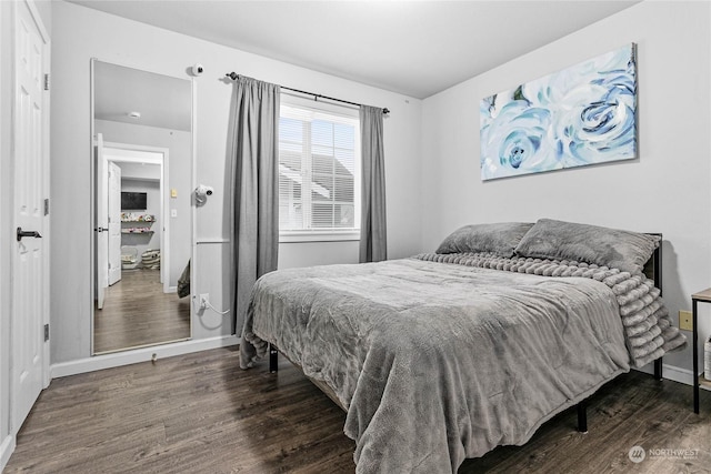 bedroom with dark wood-type flooring